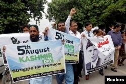 Demonstrators hold signs and chant slogans as they march in solidarity with the people of Kashmir, during a rally in Karachi, Pakistan, Aug. 5, 2019.