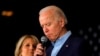 FILE - Democratic presidential candidate and former Vice President Joe Biden is accompanied by his wife Dr. Jill Biden as he addresses supporters at a rally at the Drake University Olmsted Center in Des Moines, Iowa, Feb. 3, 2020. 