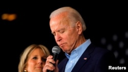 FILE - Democratic presidential candidate and former Vice President Joe Biden is accompanied by his wife Dr. Jill Biden as he addresses supporters at a rally at the Drake University Olmsted Center in Des Moines, Iowa, Feb. 3, 2020. 