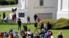 FILE - People picnic, play and walk at Peace Arch Park in Blaine, Washington, May 17, 2020. As Father's Day is observed in the United States June 21, 2020, many corovavirus restrictions have been eased in some areas of the country.