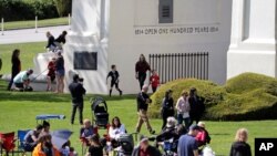 FILE - People picnic, play and walk at Peace Arch Park in Blaine, Washington, May 17, 2020. As Father's Day is observed in the United States June 21, 2020, many corovavirus restrictions have been eased in some areas of the country.