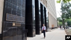 A man walks past the Export-Import Bank of the United States, July 28, 2015, in Washington.