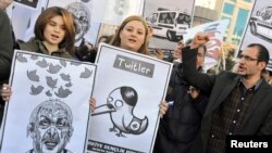 Members of the Turkish Youth Union shout anti-government slogans during a protest. 