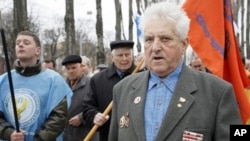 Chernobyl veterans walk during a rally in Kiev, Ukraine, Sunday, April 17, 2011.