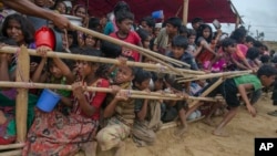 FILE - Rohingya Muslim children, who crossed over from Myanmar into Bangladesh, are squashed together as they wait to receive food handouts distributed to children and women by a Turkish aid agency at Thaingkhali refugee camp, Bangladesh, Oct. 21, 2017.