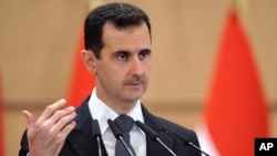 In this photo dated June 20, 2011 and released by the Syrian official news agency SANA, Syrian President Bashar Assad delivers a speech in Damascus, Syria, at Damascus University. 