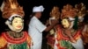 FILE - Balinese masked dancers prepare to perform during Hindu rituals of Odalan, a festival to observe a temple’s anniversary, in Bali, Indonesia, Oct. 8, 2014. 