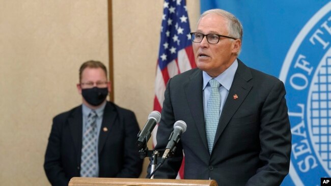 Washington Gov. Jay Inslee, right, speaks at a news conference, Aug. 18, 2021, at the Capitol in Olympia. WHO
