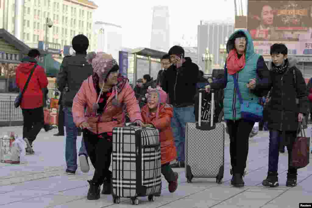 Ma Jiaqi, 5, dan ibunya tiba di Stasiun Kereta Beijing untuk menuju Changchun, provinsi Jilin di Beijing, China, dengan kereta. Menurut polisi lalu lintas akan ada lebih dari 2,9 miliar perjalanan &nbsp;di China sepajang Festival Musim Semi selama 40 hari, yang dimulai pada 24 Januari.