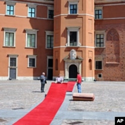 Workers prepare a red carpet in the Royal Castle courtyard one day ahead of the Central and East Europe Presidents summit, in Warsaw, May 26, 2011