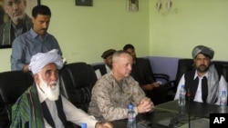 The commander of U.S. and NATO troops in Afghanistan, General John Allen (C) meets with the Governor of Logar Province, Allhaj Mohammad Tahir Sabari (L) south of Kabul, Afghanistan, June 8, 2012. 
