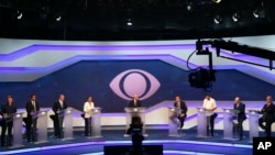 Brazil's presidential candidates before the start of a debate in Sao Paulo, Brazil. From left are Alvaro Dias of Podemos Party, Cabo Daciolo of Patriota Party, Geraldo Alckmin of the Social Democratic Party, Marina Silva of the Sustainability Network Party, Jair Bolsonaro of the National Social Liberal Party, Guilherme Boulos of the Socialism and Liberty Party, Henrique Meirelles of the Democratic Movement Party, and Ciro Gomes of the Democratic Labor Party. 