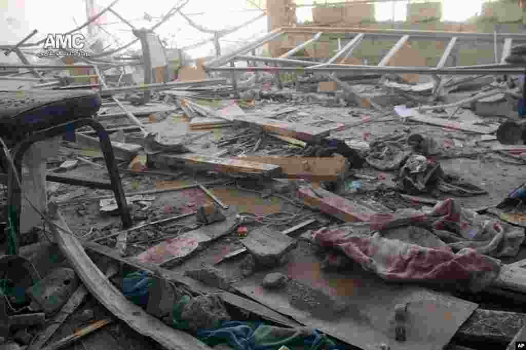 This photo provided by the anti-government activist group Aleppo Media Center shows a damaged school that was hit by a Syrian government air strike in Aleppo, April 30, 2014.