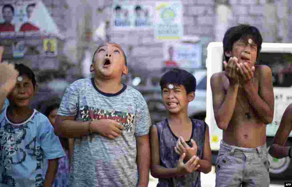Boys participate in a game during the annual Feast Day of St. Rita of Cascia in Manila, Philippines, May 19, 2019.