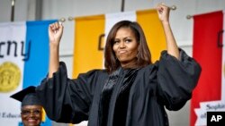 FILE - First lady Michelle Obama reacts to cheers from the class of 2016 during commencement for City College of New York, June 3, 2016. 