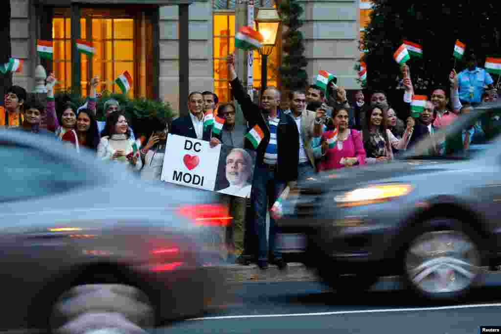 Supporters gather to greet India's Prime Minister Narendra Modi as he pays homage at the Mahatma Gandhi Statue in front of the Indian Embassy in Washington, Sept. 30, 2014. 