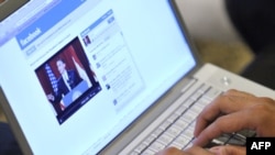 Muslim American Zabie Mansoory, 23, monitors a Facebook discussion board while watching President Barack Obama's televised coverage of President Barack Obama's speech from Cairo University, in the Sylmar area of Los Angeles, early Thursday June 4, 2009. (