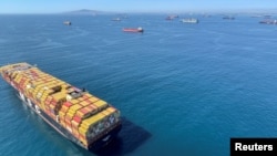 Container ships wait off the coast of the congested Ports of Los Angeles and Long Beach in Long Beach, Calif., U.S., Oct. 1, 2021.