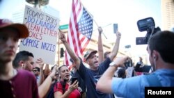 Pro Trump supporters face off with peace activists during protests outside a Donald Trump campaign rally in Phoenix, Ariz., Aug. 22, 2017.