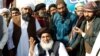 FILE - Khadim Hussain Rizvi, center, leader of the Tehreek-e-Labbaik Pakistan Islamist political party, gestures at a protest site at Faizabad junction in Islamabad, Pakistan, Nov. 27, 2017.