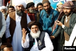 Khadim Hussain Rizvi, center, leader of Tehreek-e-Labbaik Pakistan islamist political party, at their protest site in Islamabad, Pakistan, Nov. 27, 2017.