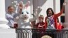 President Barack Obama and first lady Michelle Obama wave with the Easter Bunny as they greet families participating in the White House Easter Egg Roll on the South Lawn of White House in Washington, April 6, 2015.