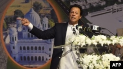 FILE - Pakistan Prime Minister Imran Khan addresses the groundbreaking ceremony for the Kartarpur Corridor in Kartarpur on Nov. 28, 2018.