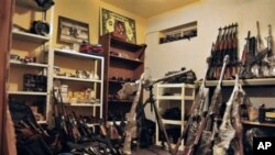 An arsenal containing grenades, grenade launchers, assault riffles and other high-powered weapons are stored inside a basement warehouse in the city of Ciudad Juarez, Mexico, April 29, 2011