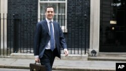 FILE - Britain's Chancellor George Osborne walks across Downing Street on his way to attend a press conference at the Foreign Office with Christine Lagarde of the International Monetary Fund, in London, May 13, 2016. 
