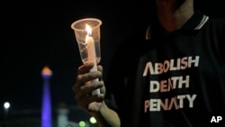 Seorang aktivis memegang lilin dalam aksi protes menentang hukuman mati di luat Istana Presiden, Jakarta, 28 Juli 2016. (Foto:ilustrasi/AP Photo/Dita Alangkara)