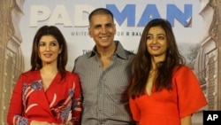 Bollywood actor Akshay Kumar, centre, with his wife Twinkle Khanna left, and Radhika Apte, right, pose for the media during the song launch of their film Pad Man in Mumbai, India, Wednesday, Dec. 20, 2017.