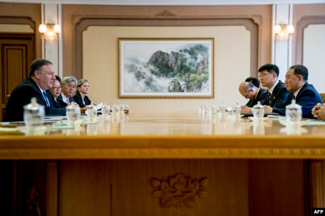 FILE - U.S. Secretary of State Mike Pompeo, left, speaks during a meeting with North Korea's director of the United Front Department, Kim Yong Chol, right, at the Park Hwa Guest House in Pyongyang, July 6, 2018.