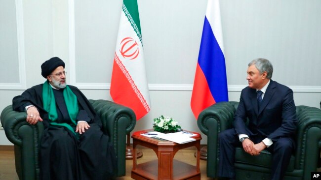In this photo released by the Russian Federation Press Service, Iranian President Ebrahim Raisi, left, and Russian State Duma speaker Vyacheslav Volodin talk to each other during their meeting in Moscow, Jan. 20, 2022.