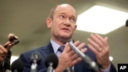 Sen. Chris Coons, a Delaware Democrat, gestures while speaking to reporters on Capitol Hill in Washington. 