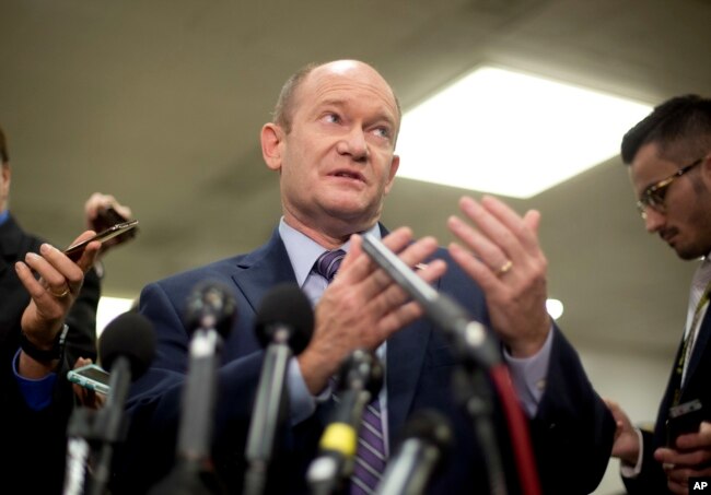 Sen. Chris Coons, a Delaware Democrat, gestures while speaking to reporters on Capitol Hill in Washington, Nov. 28, 2018.