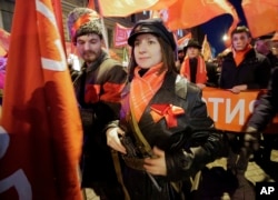 Communist Party supporters wearing Revolution ages uniform attend a rally to mark the 100th anniversary of the 1917 Bolshevik revolution in St. Petersburg, Russia, Nov. 7, 2017.