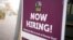 FILE - A hiring sign is posted at the entrance the of the Denver Zoo to encourage job applicants, in Denver, Colorado, Nov. 2, 2021. 