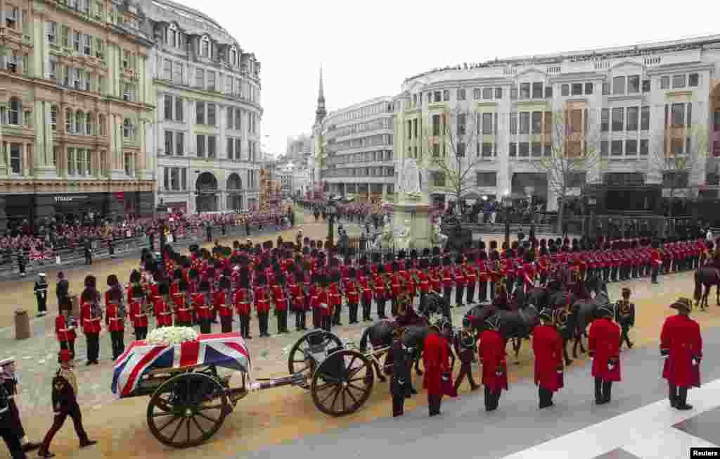 The coffin of former British Prime Minister Margaret Thatcher, draped in the Union Flag, is carried on a gun carriage drawn by the King's Troop Royal Artillery during her funeral procession in London, April 17, 2013. Thatcher, who was Conservative prime minister between 1979 and 1990, died on April 8 at the age of 87.