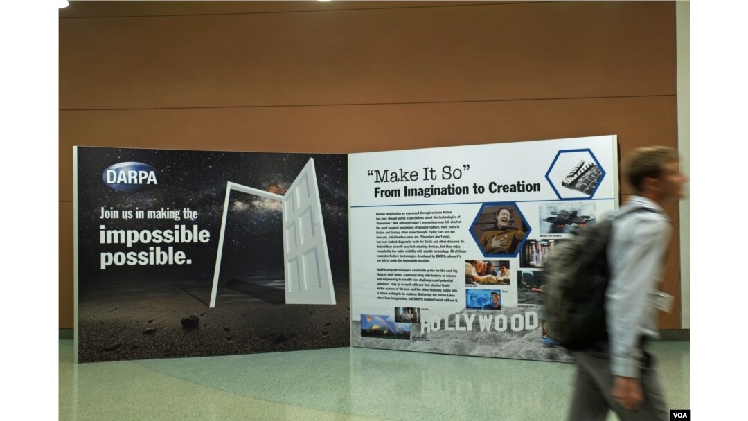 A conference visitor passes a display evoking a “Star Trek” future. The science-fiction show’s hand-held medical scanners don’t exist (yet), but near-instant diagnostic tests for diseases do. (Credit: Art Chimes/VOA)