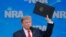 US President Donald Trump holds up an executive order as he announces the United States will drop out of the Arms Trade Treaty during a speech at the National Rifle Association-Institute for Legislative Action's148th annual meeting in Indianapolis, Indiana, U.S., April 26, 2019.