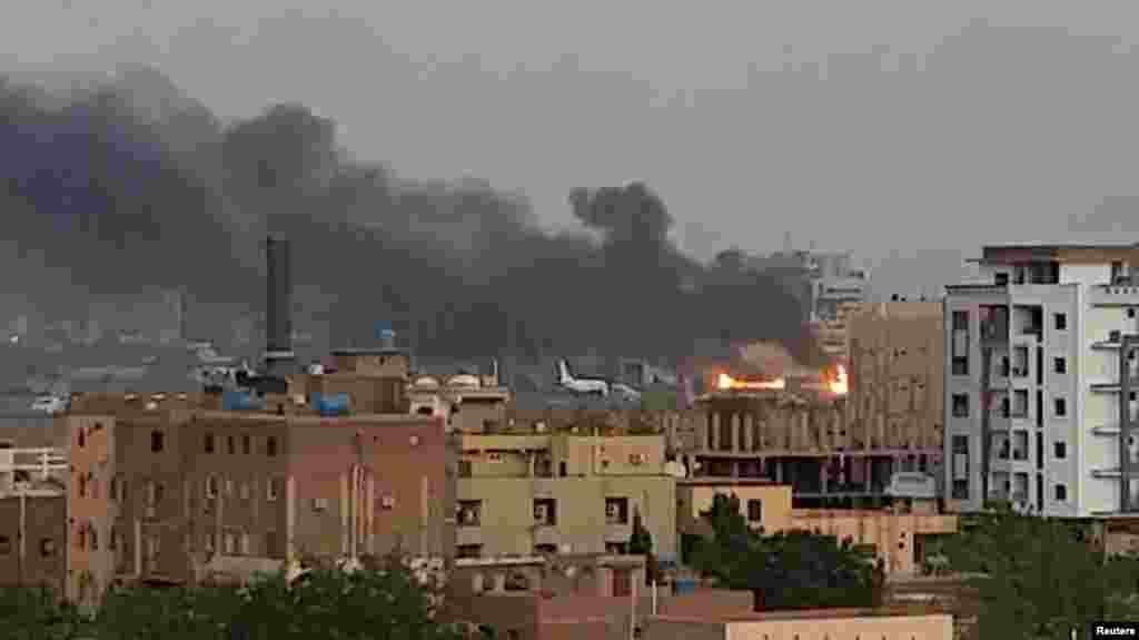 Smoke rises from the tarmac of Khartoum International Airport as a fire burns in Khartoum, Sudan. (Reuters)