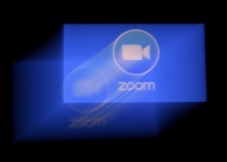 FILE- A Zoom app logo is displayed on a smartphone in Arlington, Virginia, March 30, 2020.