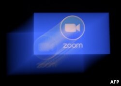 FILE- A Zoom app logo is displayed on a smartphone in Arlington, Virginia, March 30, 2020.