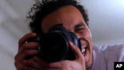 Mahmoud Abu Zaid, a photojournalist known as Shawkan, poses with his colleague's camera at his home in Cairo, Egypt, March 4, 2019. Shawkan was released after five years in prison.