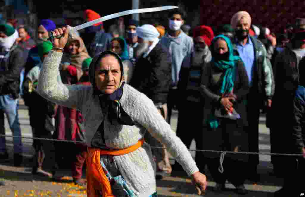 A&#160; Sikh woman displays traditional martial art skills during a religious procession ahead of the birth anniversary of Guru Gobind Singh in Jammu, India.