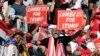 Supporters hold "Lumbees for Trump" signs as President Donald Trump speaks during a campaign rally at the Robeson County Fairgrounds in Lumberton, N.C., Saturday, Oct. 24, 2020. (AP Photo/Chris Seward)