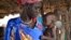 FILE - Elizabeth Nyakoda holds her severely malnourished 10-month old daughter at the feeding center for children in Jiech, Ayod County, South Sudan, Dec. 10, 2017. 