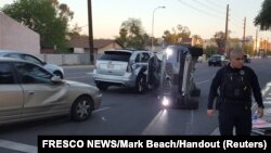 A self-driven Volvo SUV owned and operated by Uber Technologies Inc. is flipped on its side after a collision in Tempe, Ariz., March 24, 2017. 