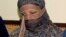 Pakistani Christian woman Asia Bibi, listens to Governor of Pakistani Punjab Province Salman Taseer, unseen, at a prison in Sheikhupura near Lahore, Nov. 20, 2010. 