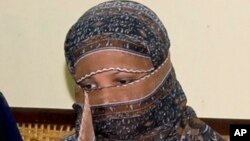 FILE - Pakistani Christian woman Asia Bibi, listens to Governor of Pakistani Punjab Province Salman Taseer, unseen, at a prison in Sheikhupura near Lahore, Nov. 20, 2010. 